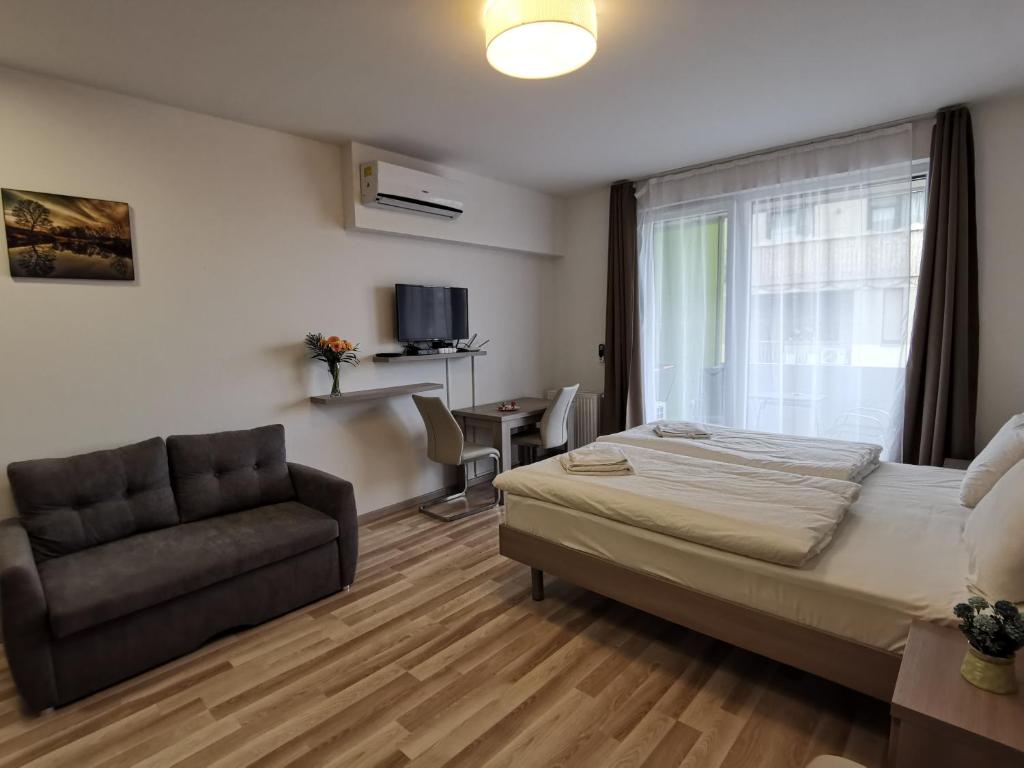 A bed or beds in a room at Corvin holiday Apartments hotel