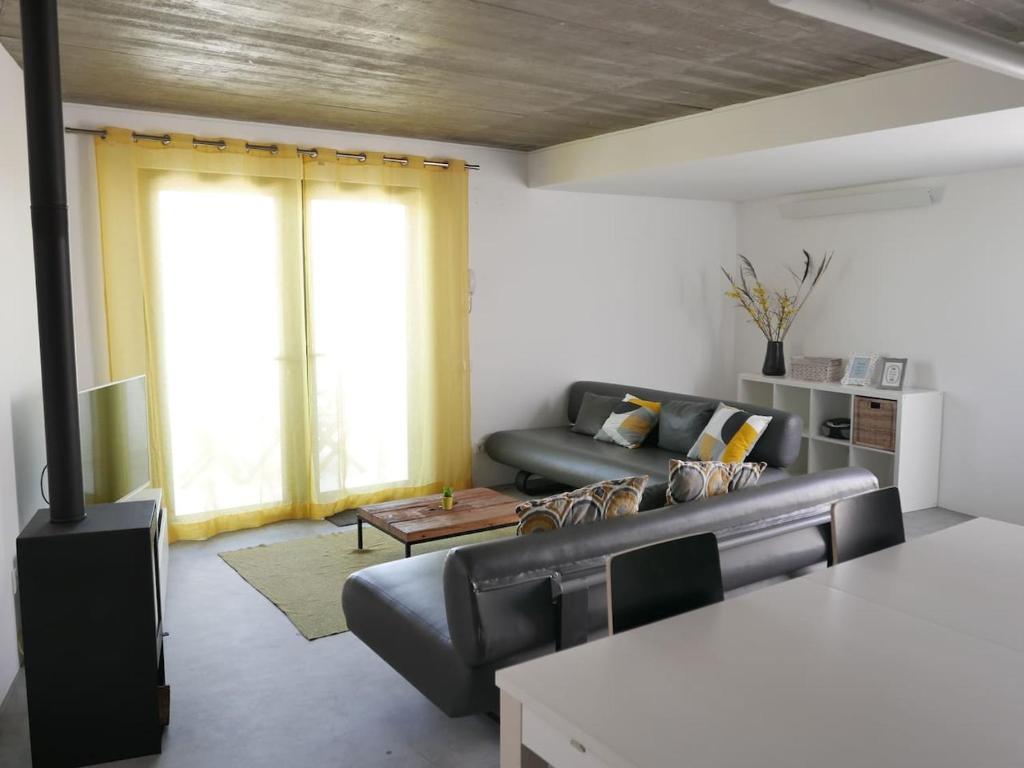 a living room with a couch and a table at Casa na Carrapateira, Aljezur in Carrapateira