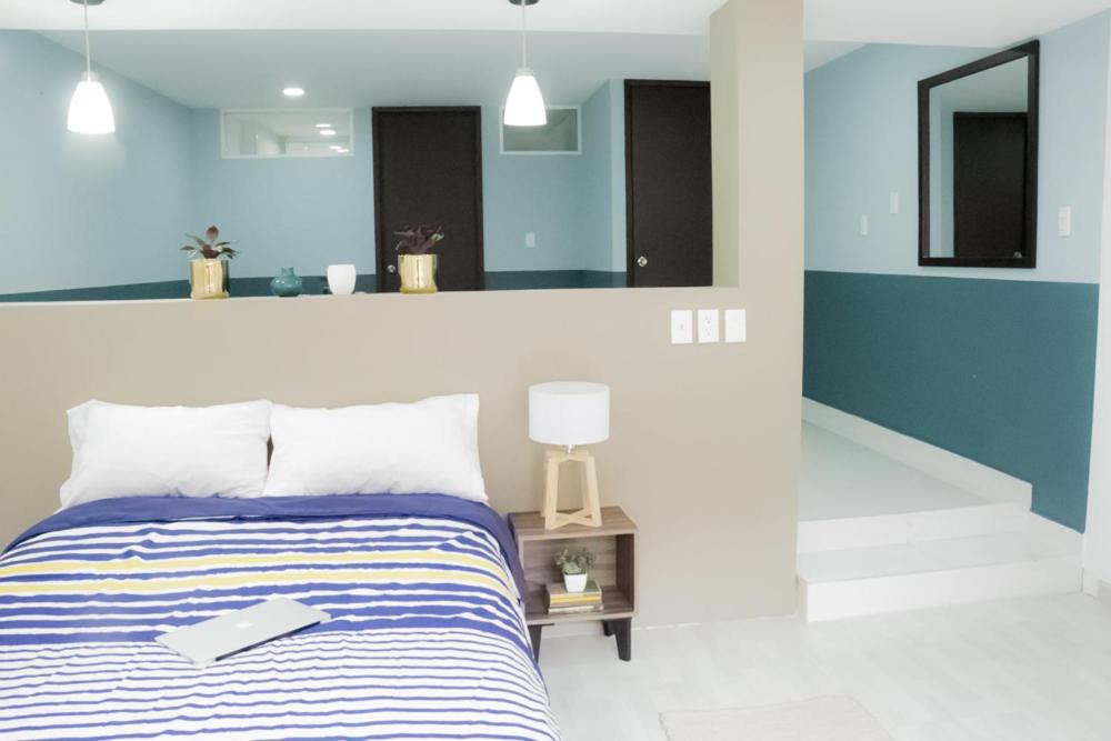 A frontal bedroom view shows the bed facing a mirrored, partially divided interior.