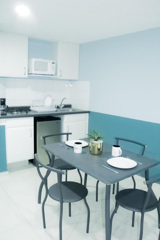 A compact kitchen-dining area with a four-seat table.