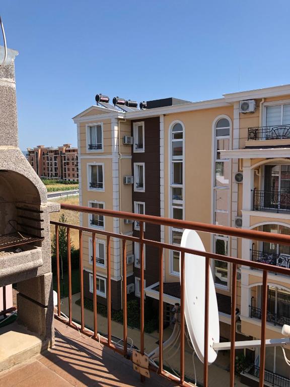 a balcony of a building with a surfboard on it at Dunav Apt.2 in Ravda