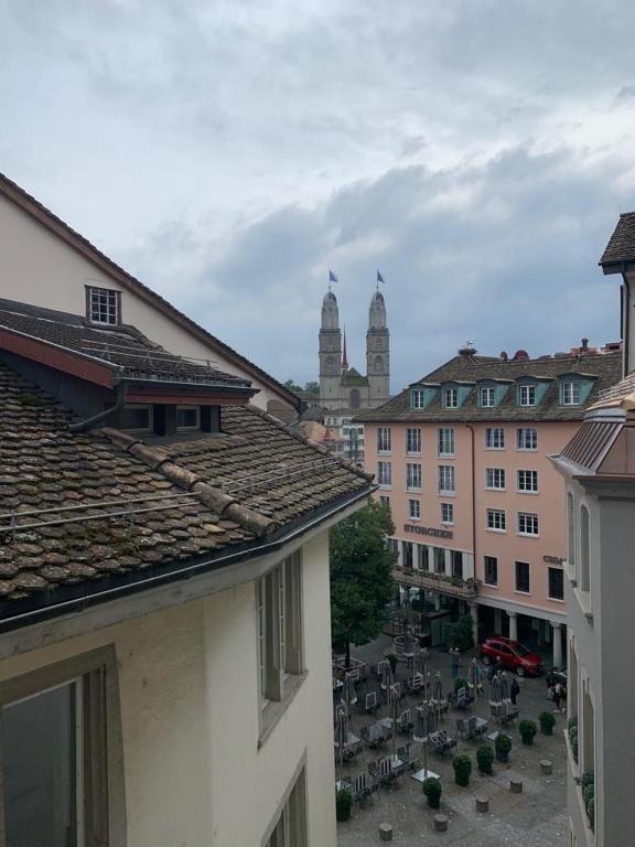 a view of a city with tables and buildings at Friendly Hostel Zürich in Zürich