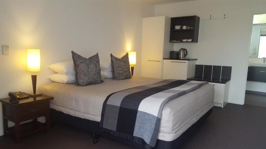 a bedroom with a large bed with pillows on it at Ski Time in Methven
