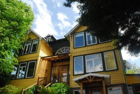 a large yellow house with windows on top of it at Casa Ayacara in Frutillar