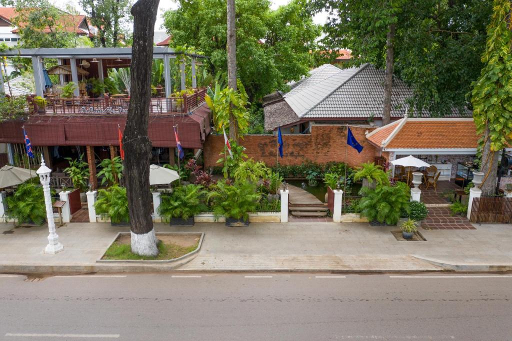 a building with a staircase leading into a courtyard at La Rivière d' Angkor Resort in Siem Reap