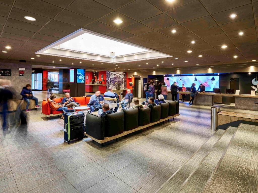 a group of people sitting in a waiting room at Ibis Milano Centro in Milan