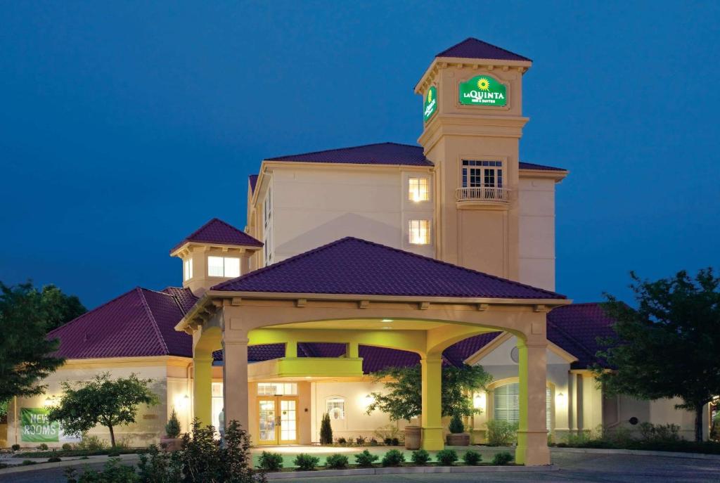 a large building with a clock tower at night at La Quinta by Wyndham Colorado Springs South Airport in Colorado Springs