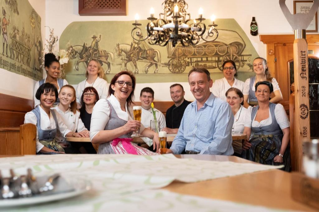 a group of people posing for a picture in a restaurant at Gasthof Neuwirt in Eugendorf