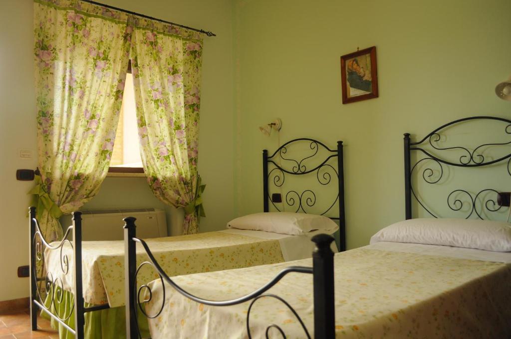 Posteľ alebo postele v izbe v ubytovaní Tenuta Bellaprima CALTAGIRONE