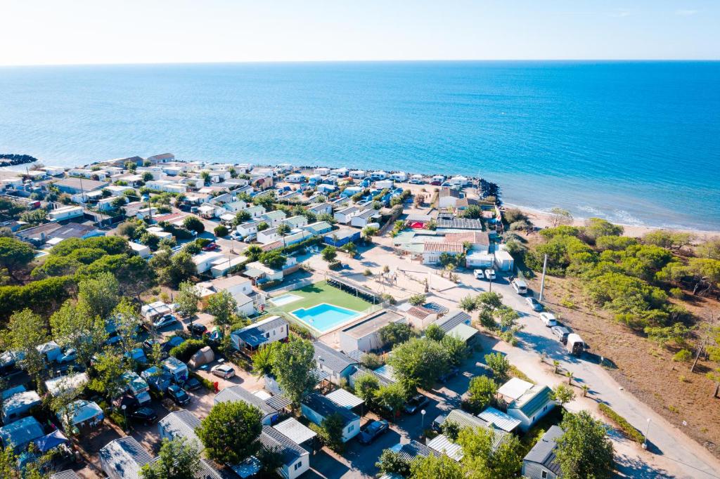 an aerial view of a village next to the ocean at Camping le Roucan West in Vias