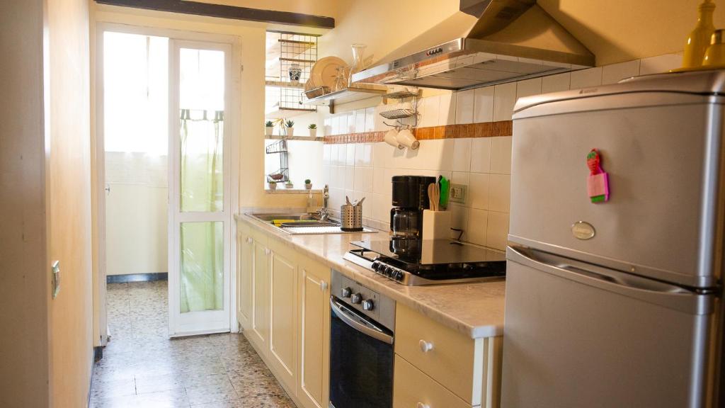 a kitchen with a stainless steel refrigerator and a window at La Casa di Enea in Pistoia