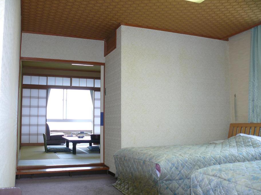 Postel nebo postele na pokoji v ubytování Hotel Ikaho Ginsui