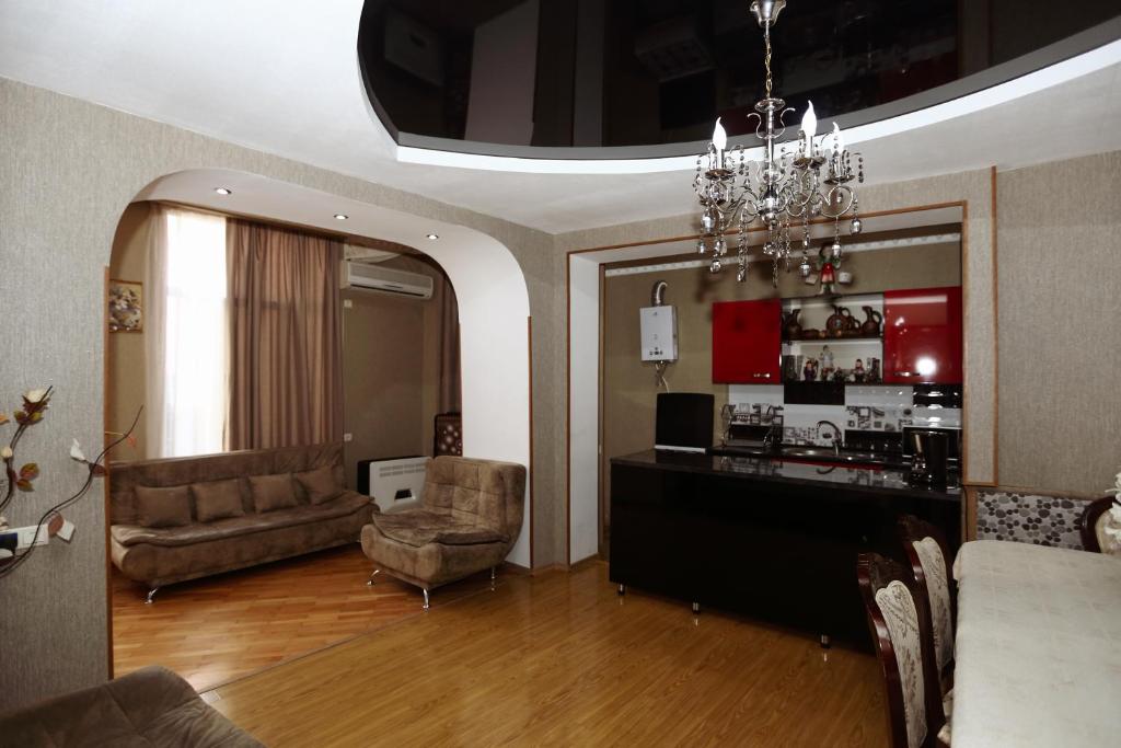 a living room with a couch and a chair at Lela Apartments in Tbilisi City