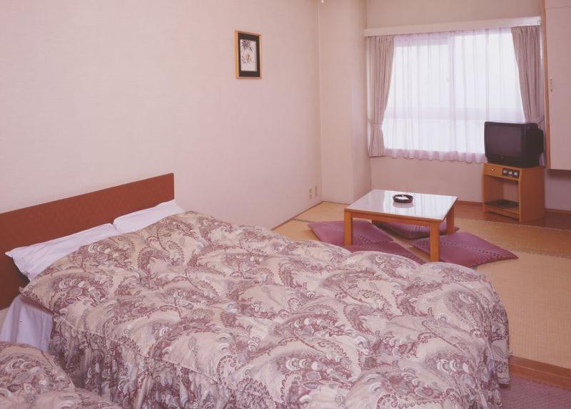 Postel nebo postele na pokoji v ubytování Hotel Chalet Yuzawa Ginsui