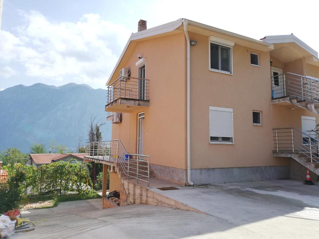 a building with stairs and balconies on it at Ruža Apartments in Kotor