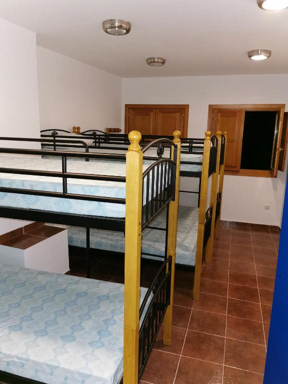 A bed or beds in a room at Casa Rural y Albergue Tormon