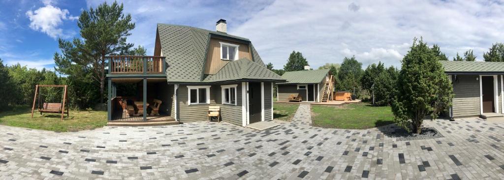 a house with a balcony on top of a driveway at Luige Residence in Reigi