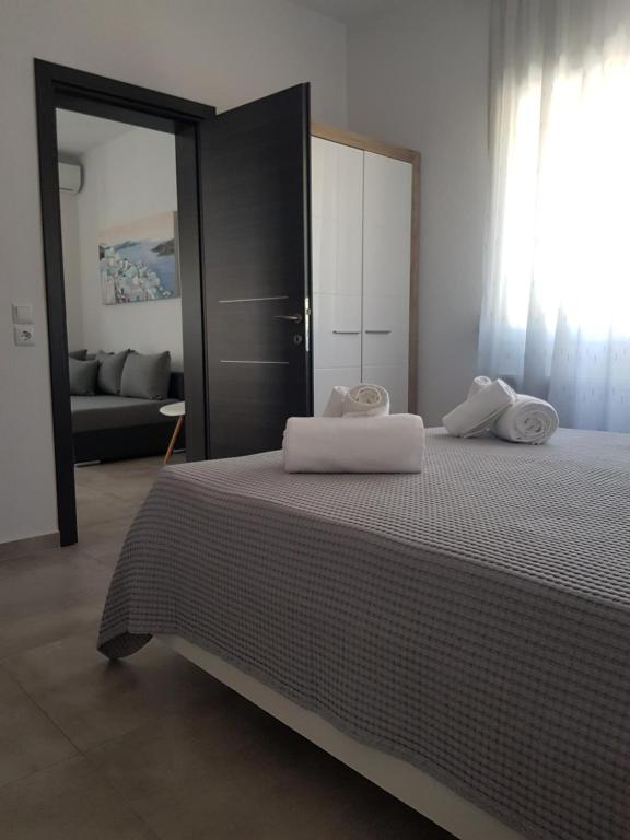 a bedroom with a bed with two towels on it at Aiolos Blu Luxury Apartments in Nea Roda