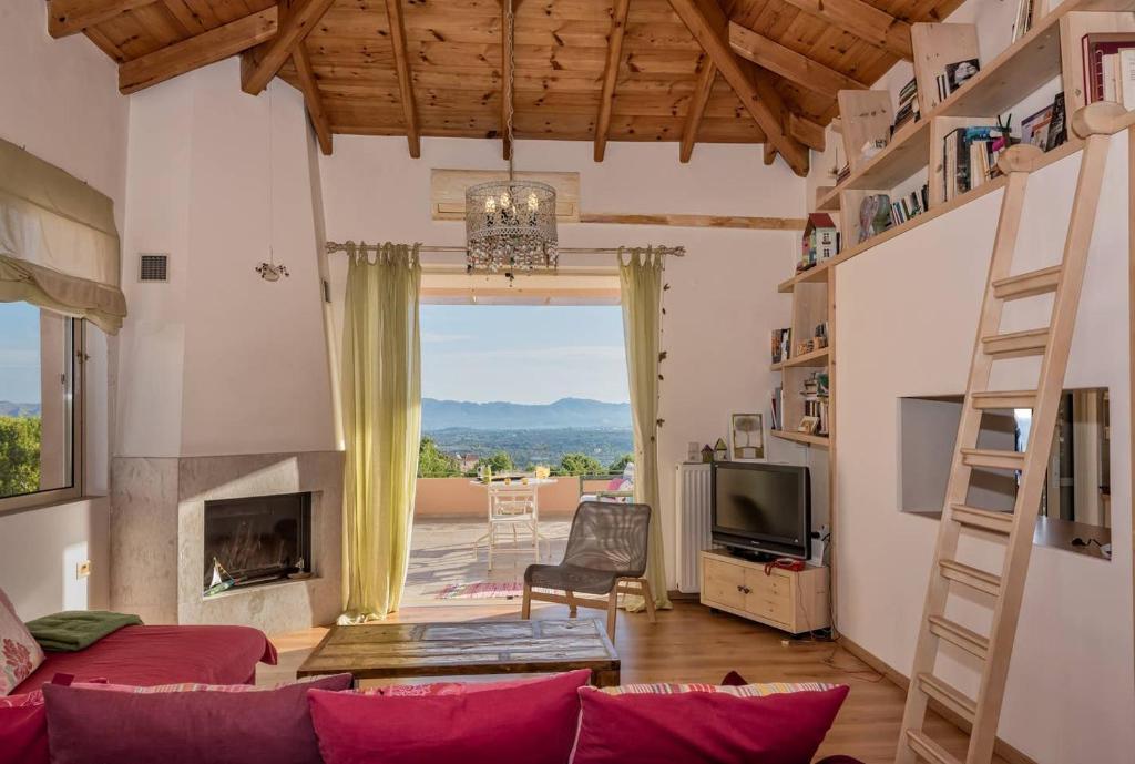 a living room with a couch and a fireplace at Irida's House, a fairylike house with supurb view in Korakiaí