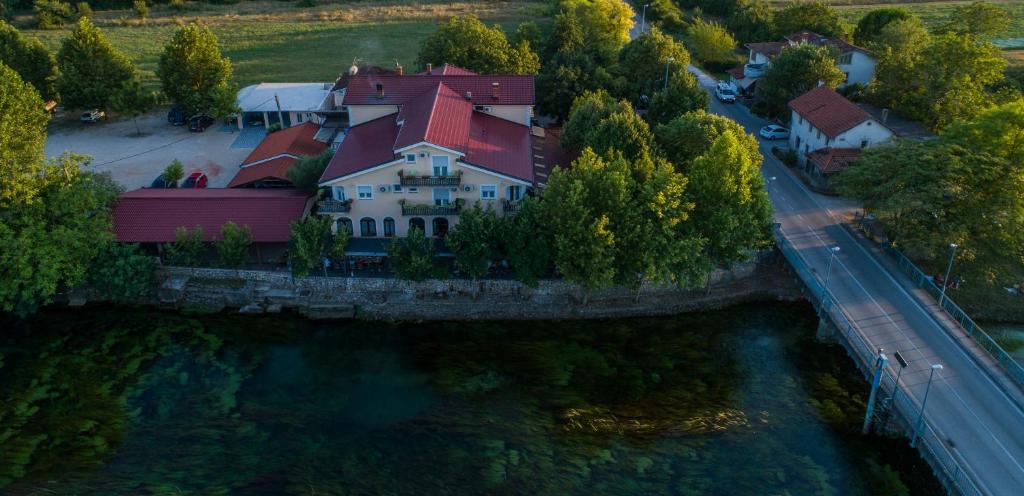 an aerial view of a house next to a river at Motel Most in Ljubuški