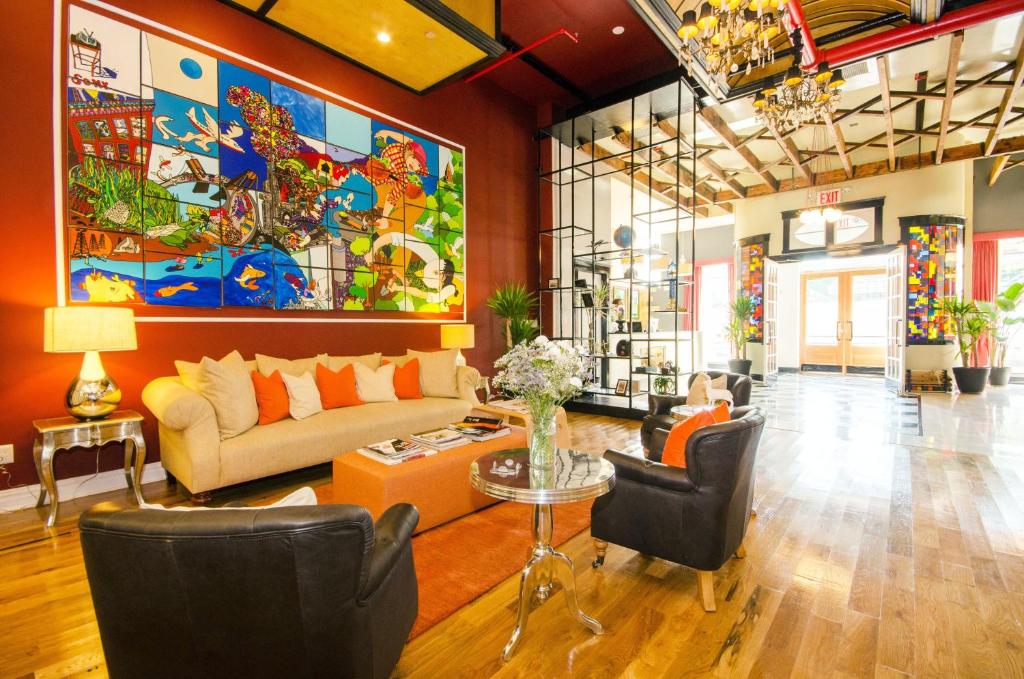 a living room filled with furniture and a painting on the wall at The Box House Hotel in Brooklyn