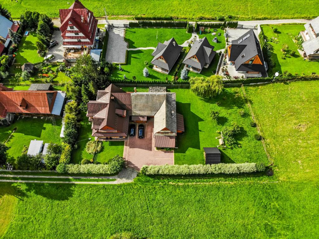 an overhead view of a house with green grass at Willa pod Jodłą in Poronin