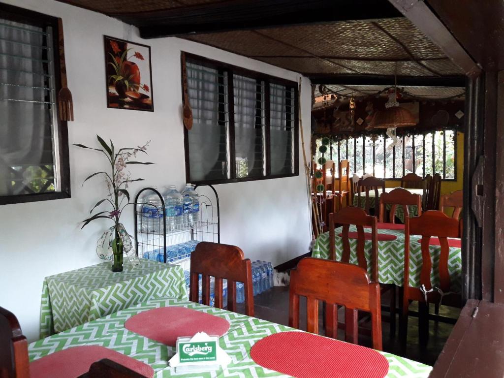 a dining room with a table and chairs and a table and chairsktop at Villa Evergreen Restaurant and Rooms in San Vicente