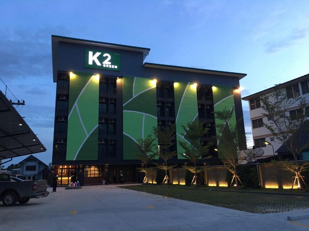 een gebouw met een bord aan de zijkant bij K2Green Hotel in Suphan Buri