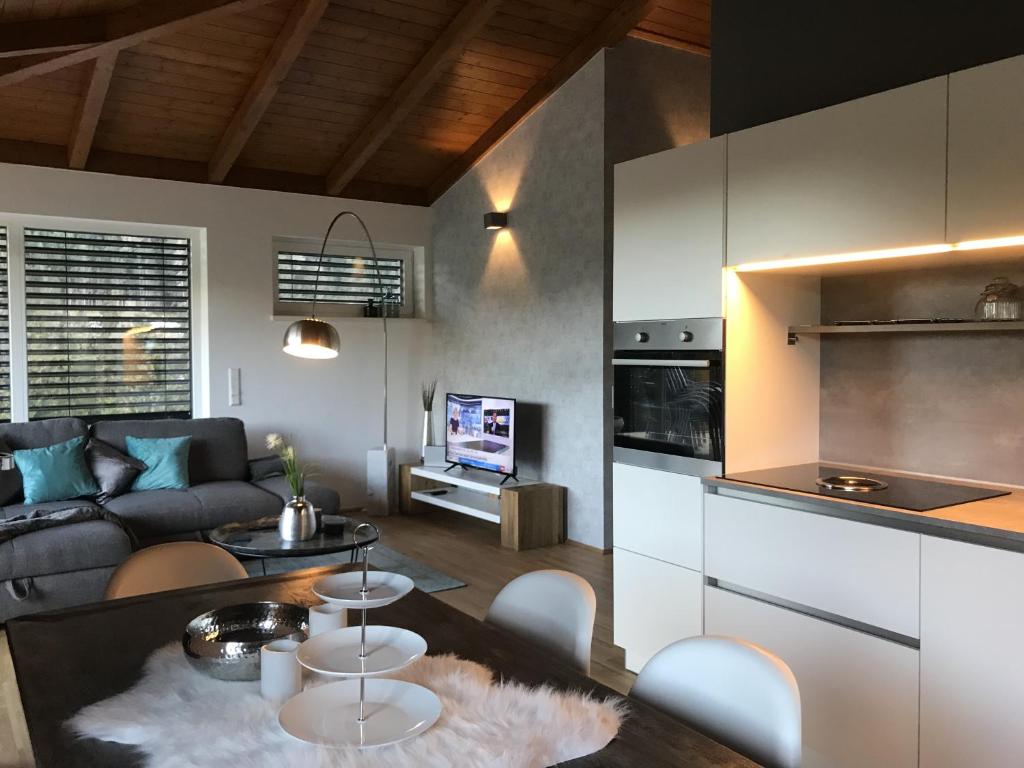 a kitchen and living room with a couch and a table at Penthouse Skyview im Natur-Erlebnispark Bad Kleinkirchheim in Patergassen