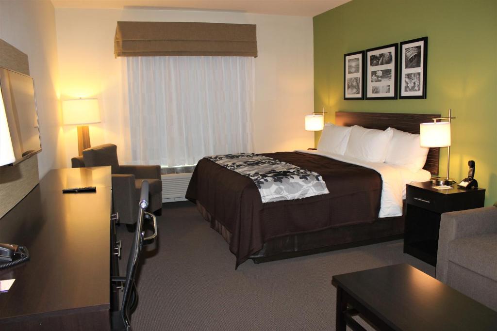 A bed or beds in a room at Sleep Inn & Suites