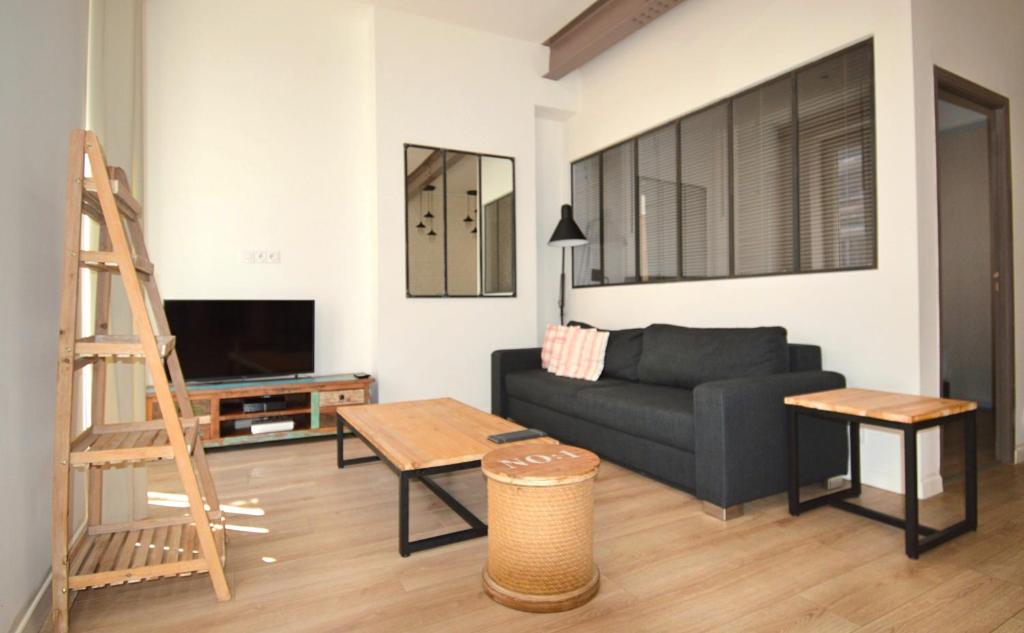 a living room filled with furniture and a couch at Les Appartements du Vieux Port in Marseille
