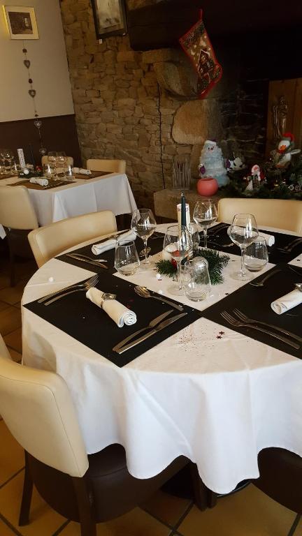 a table with wine glasses and napkins on it at La Croix Blanche in Pluvigner
