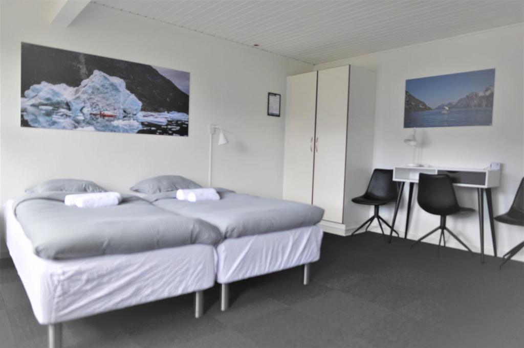 a bedroom with a bed and a desk in it at Nuuk City Hostel in Nuuk