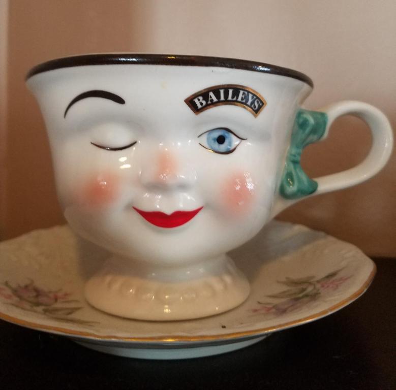 a coffee cup with a smiling face on a saucer at Ocean City Mansion in Ocean City