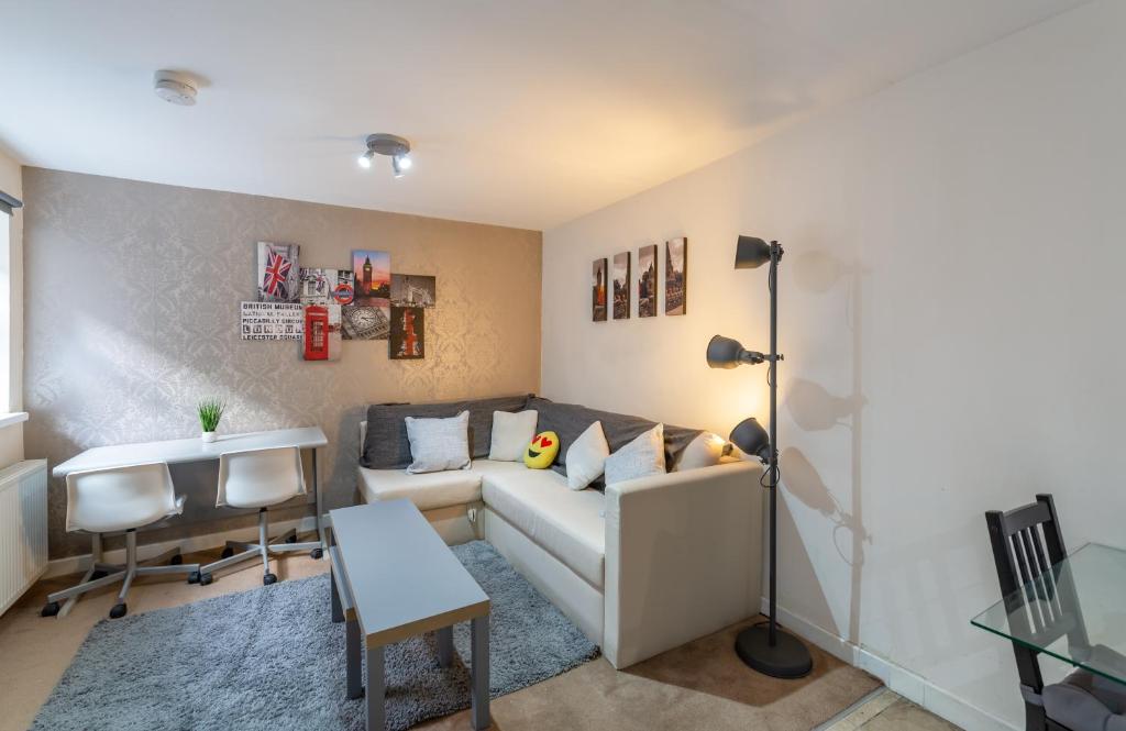 a living room with a couch and a table at 3 bedroom apartment newcastle city centre in Newcastle upon Tyne