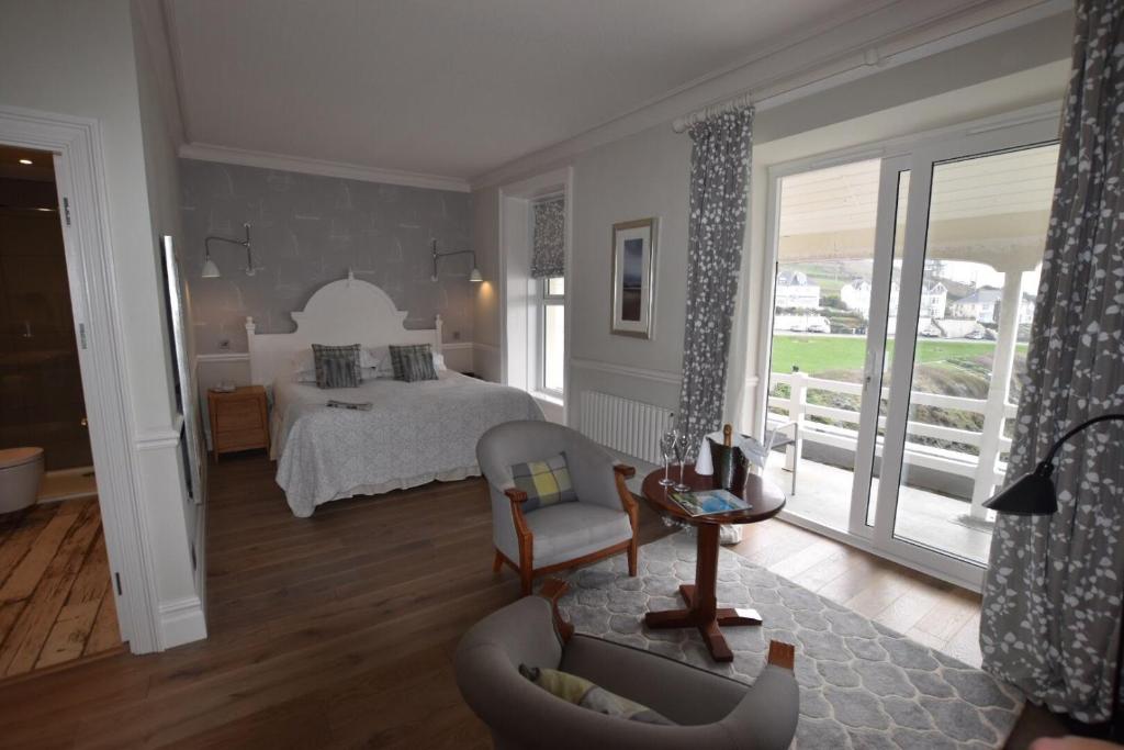 a bedroom with a bed and a living room at Watersmeet Hotel in Woolacombe