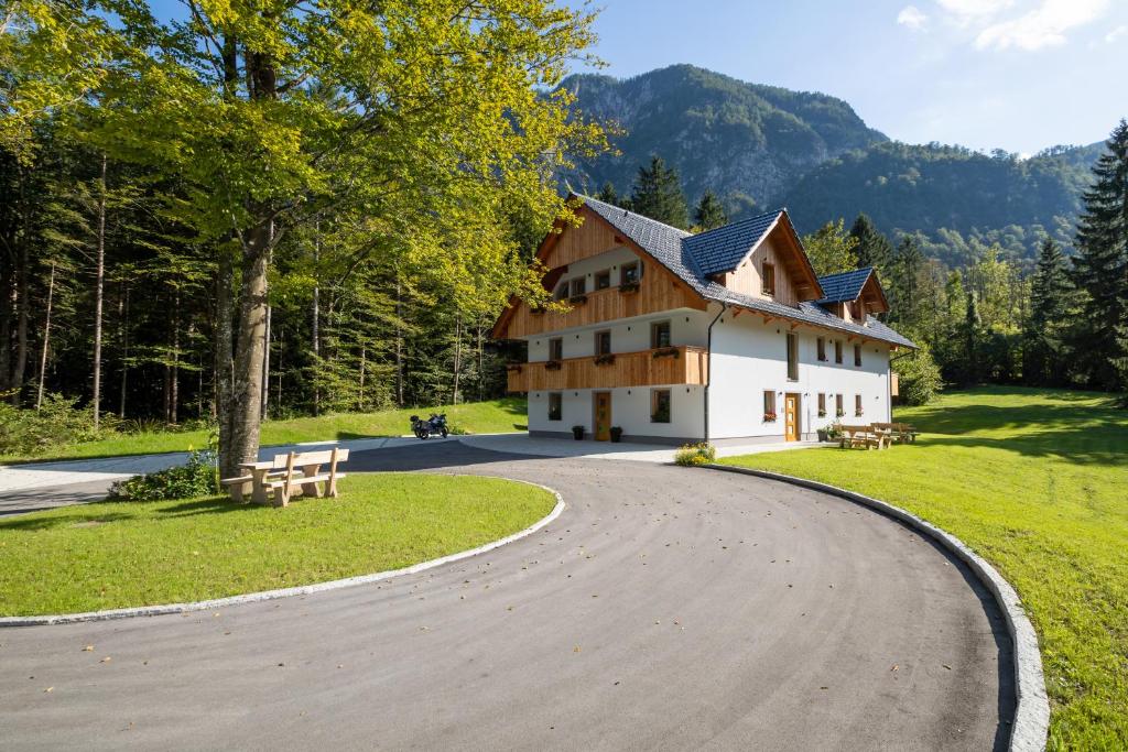 a winding road in front of a house at Bohinj Apartments Goldhorn Kingdom in Bohinj