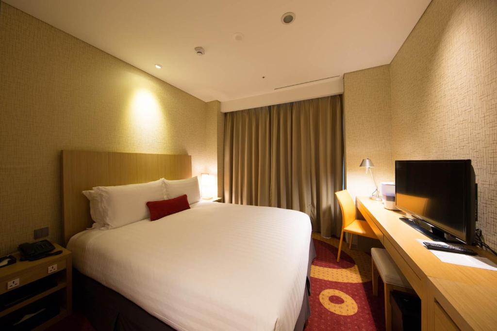 Postel nebo postele na pokoji v ubytování Solaria Nishitetsu Hotel Busan