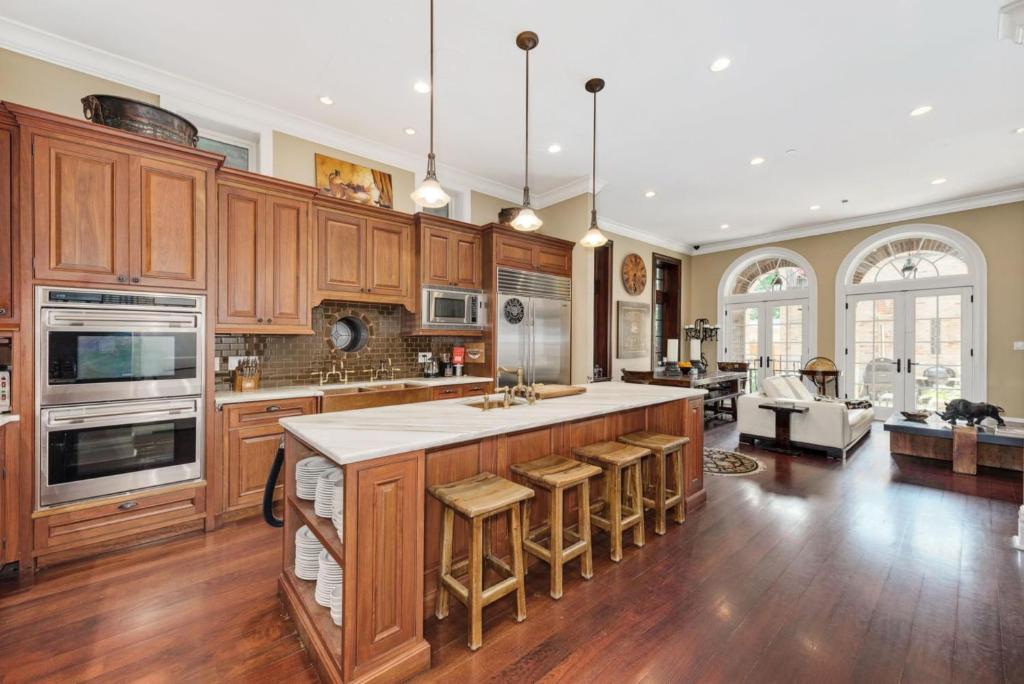 a large kitchen with wooden cabinets and a large island at Villa D' Citta in Chicago