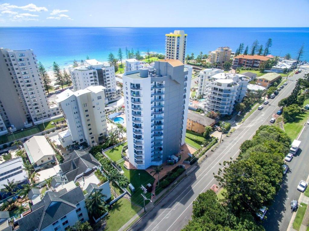 an aerial view of a city with buildings and the ocean at Rainbow Commodore Coolangatta in Gold Coast