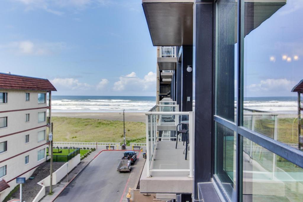 a balcony with a view of the beach from a building at Sand & Sea: The Holladay (418) in Seaside