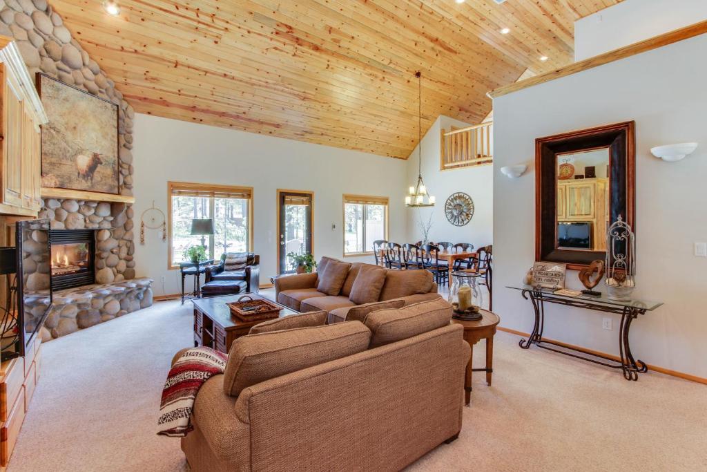 a living room with a couch and a fireplace at Catkin Lane 04 | Discover Sunriver in Sunriver