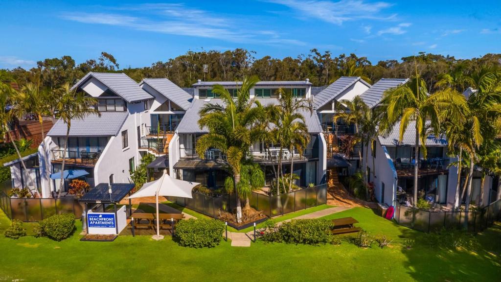 an aerial view of a resort with palm trees at Byron Bay Beachfront Apartments in Byron Bay