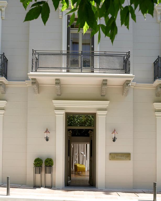 a building with a balcony on top of it at Marpessa Hotel & Spa in Agrinion