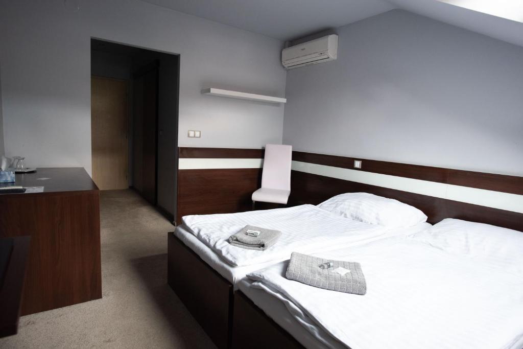pokój hotelowy z łóżkiem z kapeluszem w obiekcie Penzion u Trávníčka w mieście Modřice