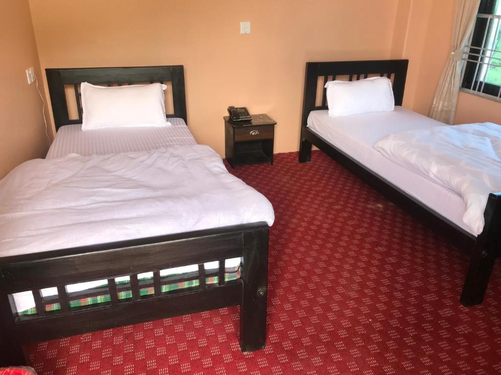 Postel nebo postele na pokoji v ubytování Hotel Brisha Sarangkot