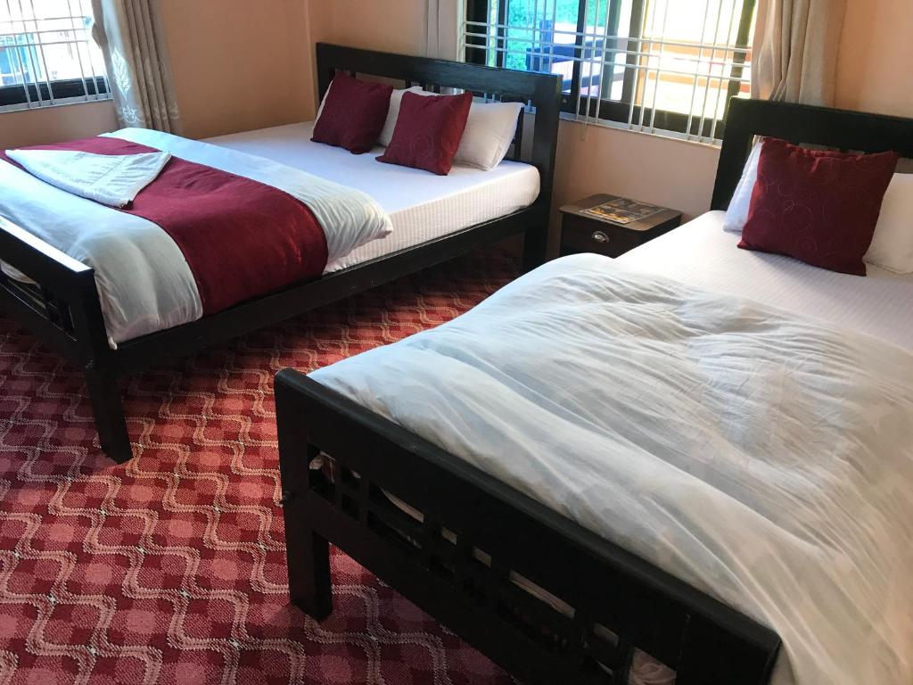 Postel nebo postele na pokoji v ubytování Hotel Brisha Sarangkot