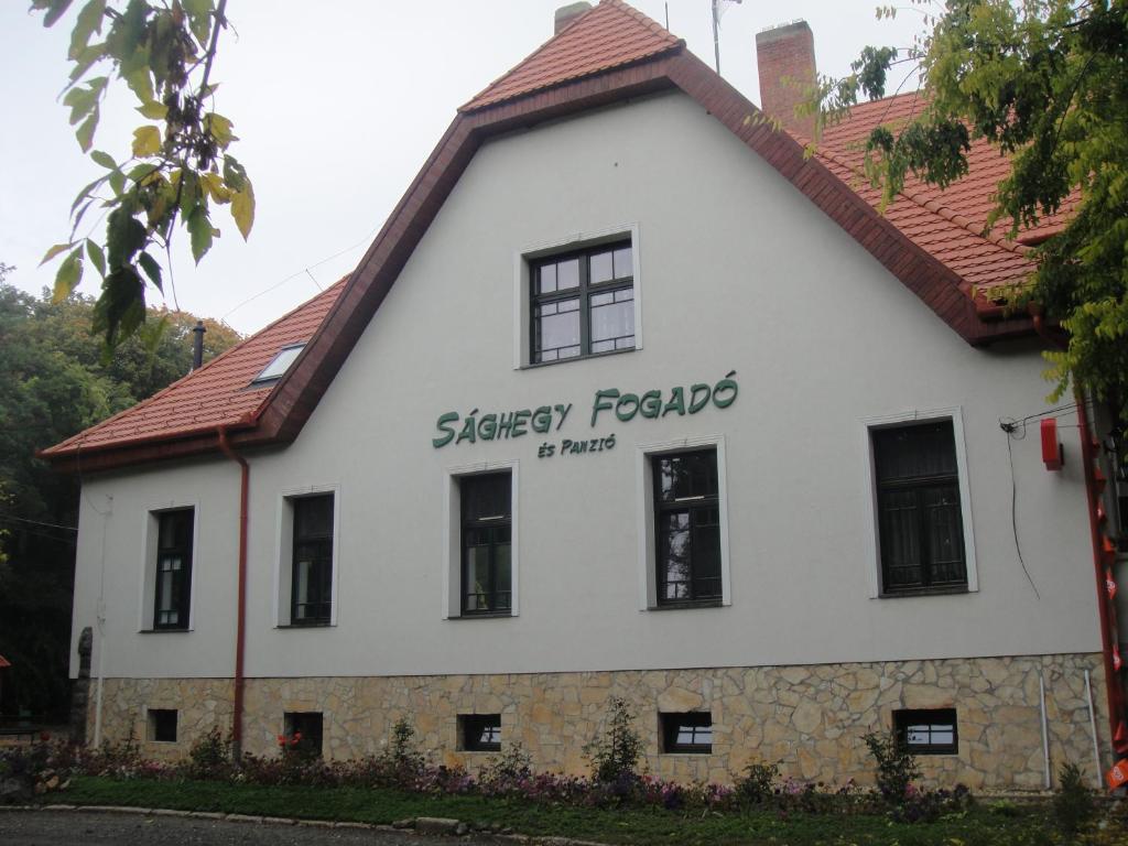 a white building with a red roof at Sághegy Fogadó és Panzió in Celldömölk