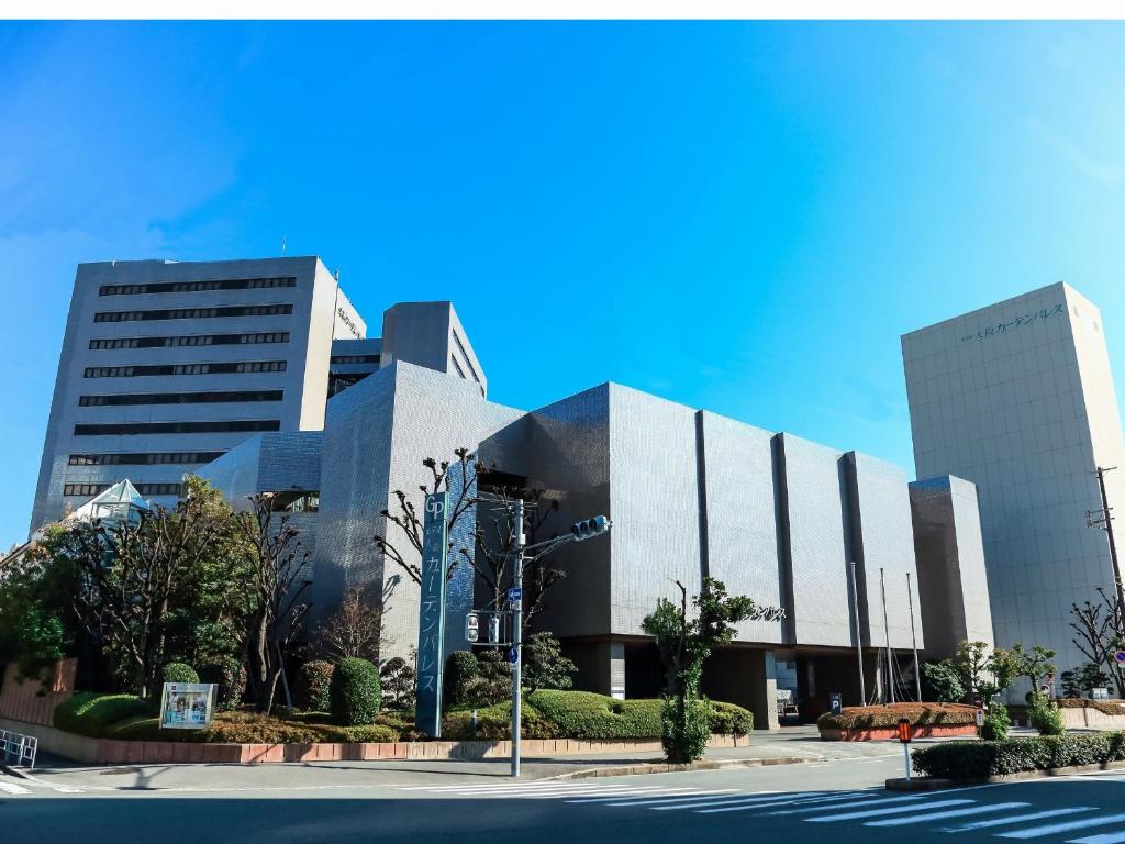 a building with two tall buildings in front of a street at Osaka Garden Palace in Osaka