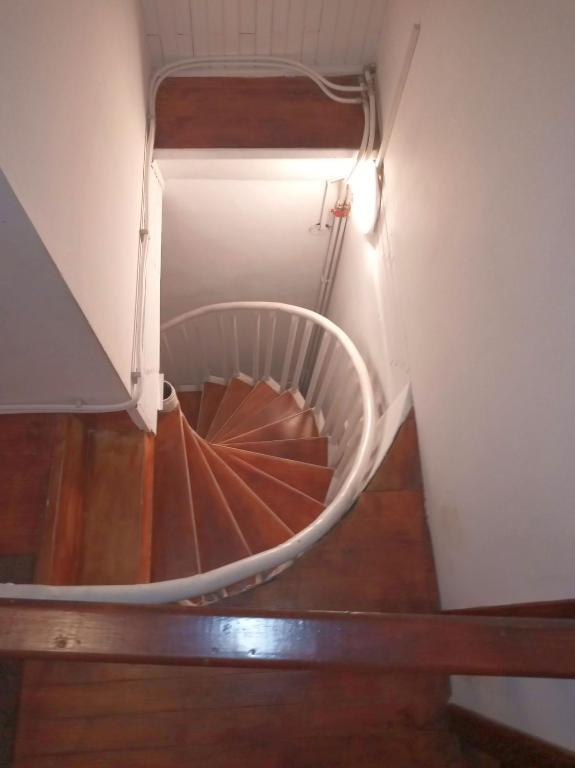 a spiral staircase with a light on top of it at Pensiunea Geostar 2 in Curtea de Argeş
